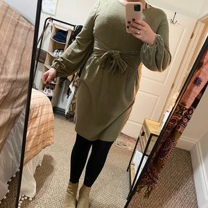 Green, long sleeved dress.